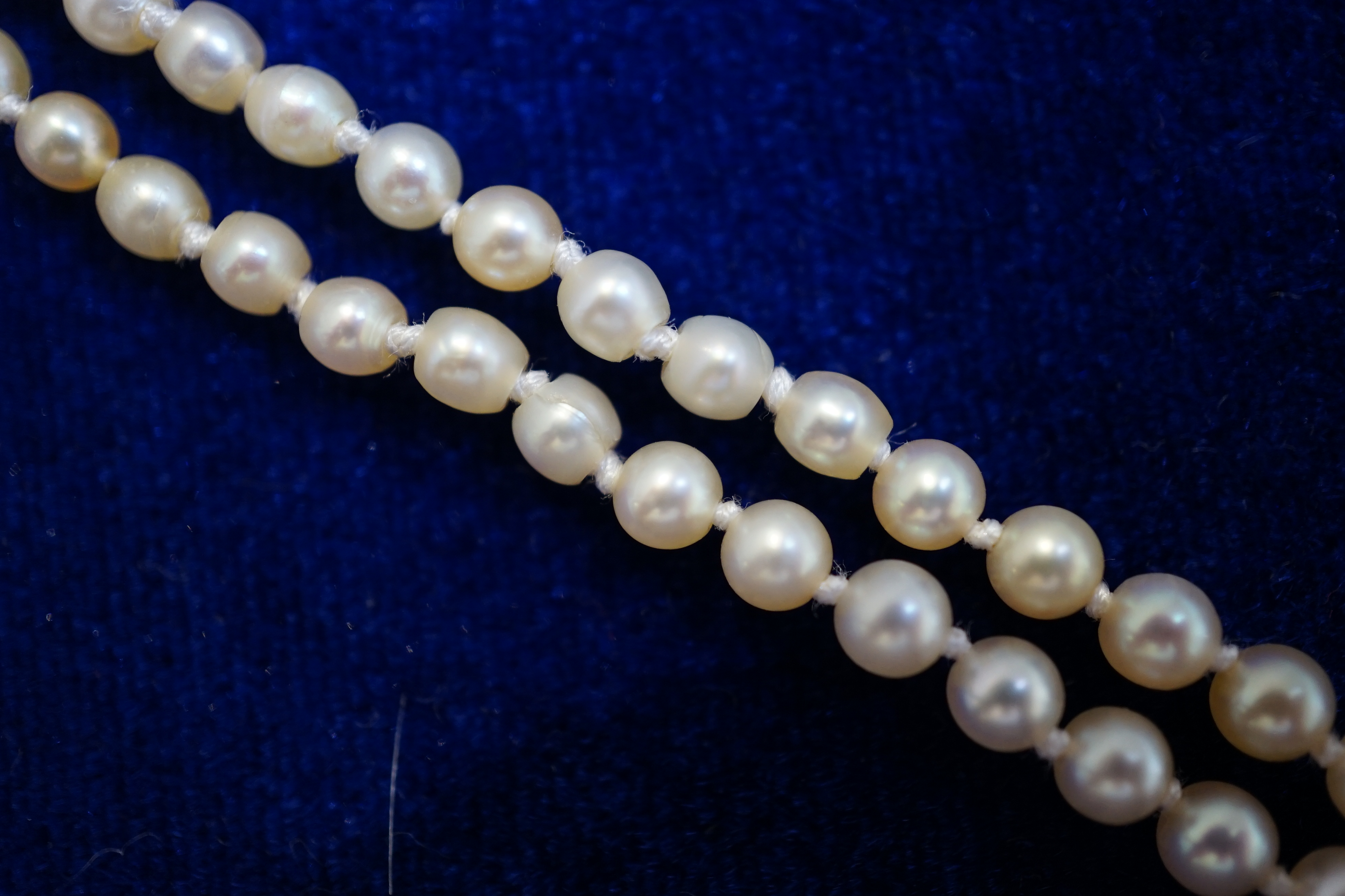 An early 20th century single strand graduated natural pearl and seed pearl necklace, with three stone diamond set clasp and Anchor Cert report dated 27/6/2014 stating an extensive sample to be natural pearls
